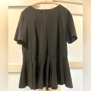 Elegant Akris black peplum blouse with curved hem detail, size L